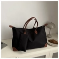 Detalle del bolso tote de nailon negro con asas de cuero marrón y un estuche a juego - Negro