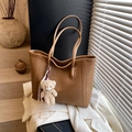 Minimalist brown leather tote bag with plush bear charm on white suit background - Brown with Pendant