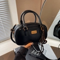 Glossy black bowling handbag with gold logo plate and shoulder strap for daily use - With Charm / Black