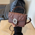 Brown quilted crossbody bag with rhinestone buckle and top handle in a minimalist style - Coffee