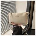 Close-up of cream-white leather envelope bag with gold fashion text and silver chain - White