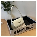 Détail d'un sac baguette blanc crème avec boucle en nœud doré dans un coffret cadeau - Blanc Cassé