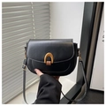 Detail of a black leather saddle bag featuring a gold U-shaped buckle and adjustable strap - Black