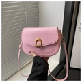 Detail of light pink saddle bag with golden horseshoe buckle and sleek leather texture - Pink