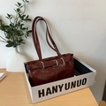 Vintage burgundy glossy shoulder bag with silver buckles and retro strap design - Red