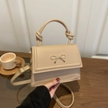 Beige minimalist top-handle bag with golden bow buckle and knotted strap detail - Khaki