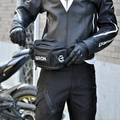 Detail of waterproof motorcycle waist bag featuring multi-pocket design and adjustable strap - Black