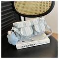 Detail of blue striped canvas shoulder bag with dual front pockets and star charm - With Pendant / Blue-Grey