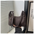 Detailed view of dark brown faux leather hobo bag with adjustable strap and skull tassel - With Pendant / Brown