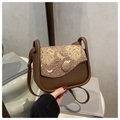 Detail of vintage-style crossbody bag with intricate embroidery and brown faux leather finish - Coffee