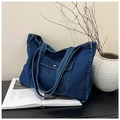 Detail of blue denim tote bag with front flap pocket and orange contrast stitching - Dark Blue