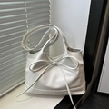 Minimalist white tote bag with bow detail and twin handles in a sleek indoor setting - White