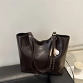 Vintage brown leather tote bag with baseball charm on a leather chair scene - With Pendant / Brown