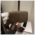 Detail showing deep brown V-quilted camera bag with wide fabric strap and gold hardware - Coffee