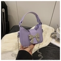 Close-up of purple mini tote bag featuring silver bow clasp and chain strap - Purple