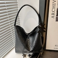 Black woven texture shoulder bag with large star charms and drawstring closure - Black