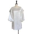 Detail of elegant white satin dress featuring ruffled off-shoulder neckline and lantern sleeves - White