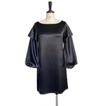 Detail of black satin dress featuring off-shoulder ruffles and elegant lantern sleeves - Black