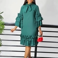 Detail of dark green dress with tiered ruffle sleeves and a bow neckline detail - Green
