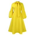 Detailed view of yellow lantern sleeves and elegant bow neckline on a social party dress - S / Yellow