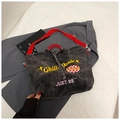Detail of grey denim tote bag with yellow CHILL vibes embroidery and red strap handles - Black