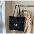 Detail of black pleated tote bag featuring silver butterfly buckle and side zippers - With Pendant / Black