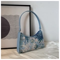 Detail of floral jacquard underarm bag with light blue PU leather trim on white silk - Blue