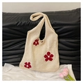 Close-up of crochet knit tote bag with cream hollow weave and red floral details - White