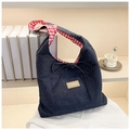 Close-up of denim tote bag with red gingham lining and fashion leather label - Pink Checkered Side B