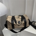 Khaki large capacity travel duffel bag with black handles and adjustable shoulder strap - Khaki
