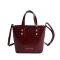 Elegant wine red bucket bag in glossy patent leather with top handles and shoulder strap - Red