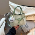 Mint green pleated bucket bag with woven texture, leather buckle and plush charm - With Charm / Green