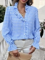 Close-up of blue gingham plaid blouse featuring ruffled collar and flared cuffs detail - Sky Blue