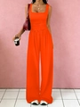 Detail view of the high-waisted wide-leg trousers with pleated waist design in orange - Orange
