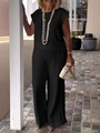 Detail of elegant black two-piece set featuring sleeveless top and high-waist trousers - S / Black