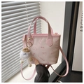 Detailed view of pink bucket bag with embossed patterns and cloud plush charm - With Pendant / Pink