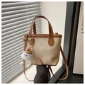 Detail of beige mini bucket bag with embossed butterfly patterns and plush doll charm - With Pendant / Off-white