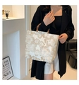 Detalle de los patrones florales de jacquard y el asa de bambú en el bolso champán - Beige