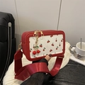 Retro red cherry print crossbody camera bag with wide strap and cherry charm detail - Red