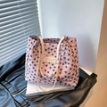 Pink tote bag with black bow patterns and wrinkled texture on a white book - With Pendant / Pink