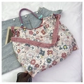 Floral canvas tote bag featuring wide red checkered straps and blue-red rope handle details - Red