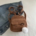 Mini brown corduroy backpack for women featuring cute black smiley prints and a plush ball - Brown