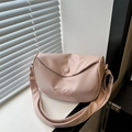 Pink PU leather crossbody bag with butterfly embroidery and soft texture on windowsill - Pink