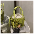 Detail of neon green sequin bucket bag with satin drawstring liner and silver chain strap - Green