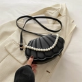 Elegant black shell crossbody bag featuring quilted patterns and a stylish pearl handle - Black