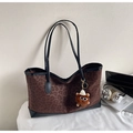 Leopard print tote bag with plush charm, laptop and headphones on a white desk - With Charm / Brown