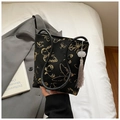 Detail of black bucket bag with gold butterfly embroidery and white flower tassel charm - Butterfly Embroidery (1343040) / Black