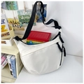 Close-up of a white half-moon nylon crossbody bag with wide black strap and rope zipper pull - White