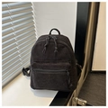 Detailed macro view of black corduroy fabric texture and zipper on the mini backpack - Black