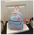 Close-up of pastel gradient nylon backpack featuring white star patterns and petal zipper - Blue